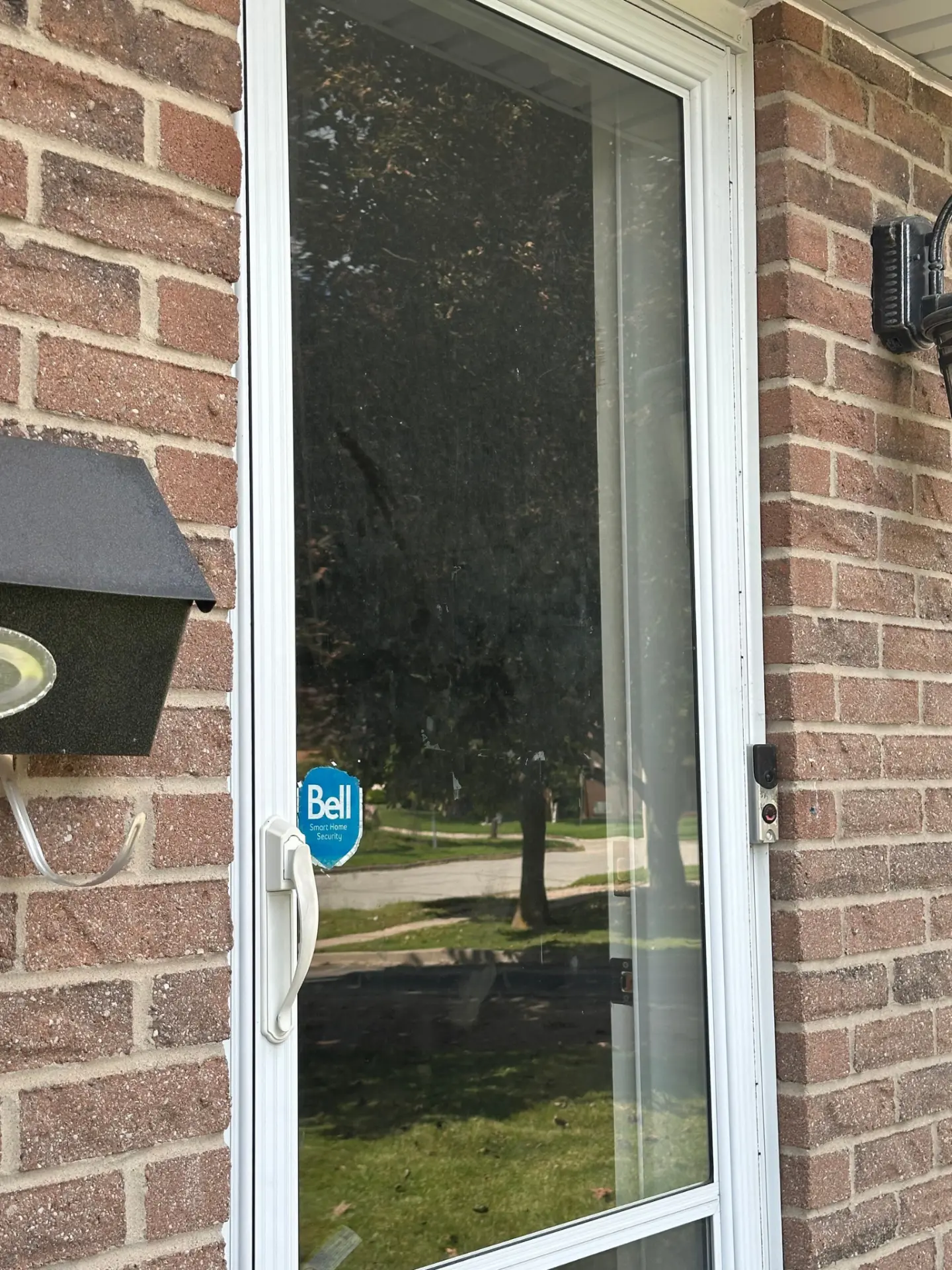 Patio door window cleaning in Kitchener, Ontario — hazy, streaked glass on the left revealed sparkling clean and crystal clear on the right by Daylight Window Cleaning — before